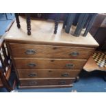 A HARDWOOD CHEST OF DRAWERS