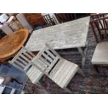 A TEAK GARDEN TABLE AND TWO MATCHING CHAIRS