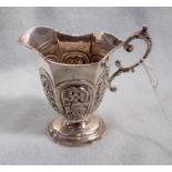 A SILVER CREAM JUG, WITH PANELLED REPOUSSE DECORATION