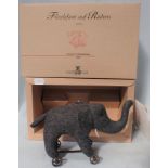 A STEIFF 12CM FELT ELEPHANT ON WHEELS