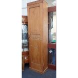 A 19TH CENTURY STRIPPED PINE CUPBOARD OF NARROW PROPORTIONS