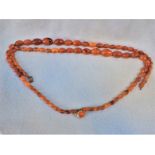 AN AMBER BEADED NECKLACE