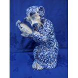 A DELFT MONKEY, HOLDING A LOOKING-GLASS