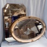 A GILT AND PAINTED OVAL-FRAMED WALL MIRROR