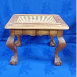 A DUTCH STYLE HARDWOOD STOOL WITH A CANE TOP AND BALL AND CLAW FEET