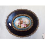 A 19TH CENTURY FRENCH PORCELAIN PLAQUE IN EBONISED AND GILDED FRAME
