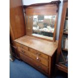 AN OAK CHEST OF DRAWERS