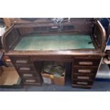 A 1920S OAK ROLL TOP DESK