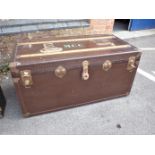 AN EARLY 20TH CENTURY TRAVELLING TRUNK, WITH LABELS