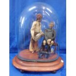A 19TH CENTURY MODEL OF TWO FIGURES UNDER A GLASS DOME