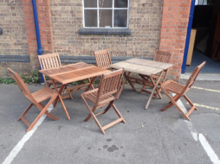 TWO TEAK FOLDING GARDEN TABLES AND SIX CHAIRS