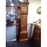 AN OAK LONGCASE CLOCK