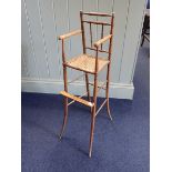 A REGENCY BABY'S OR DOLL'S FAUX-BAMBOO HIGH CHAIR, OF DELICATE PROPORTIONS