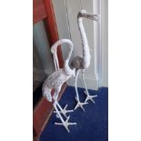 A PAIR OF CAST METAL GARDEN STORKS