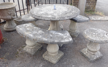 A RECONSTITUTED STONE GARDEN TABLE AND SEATS