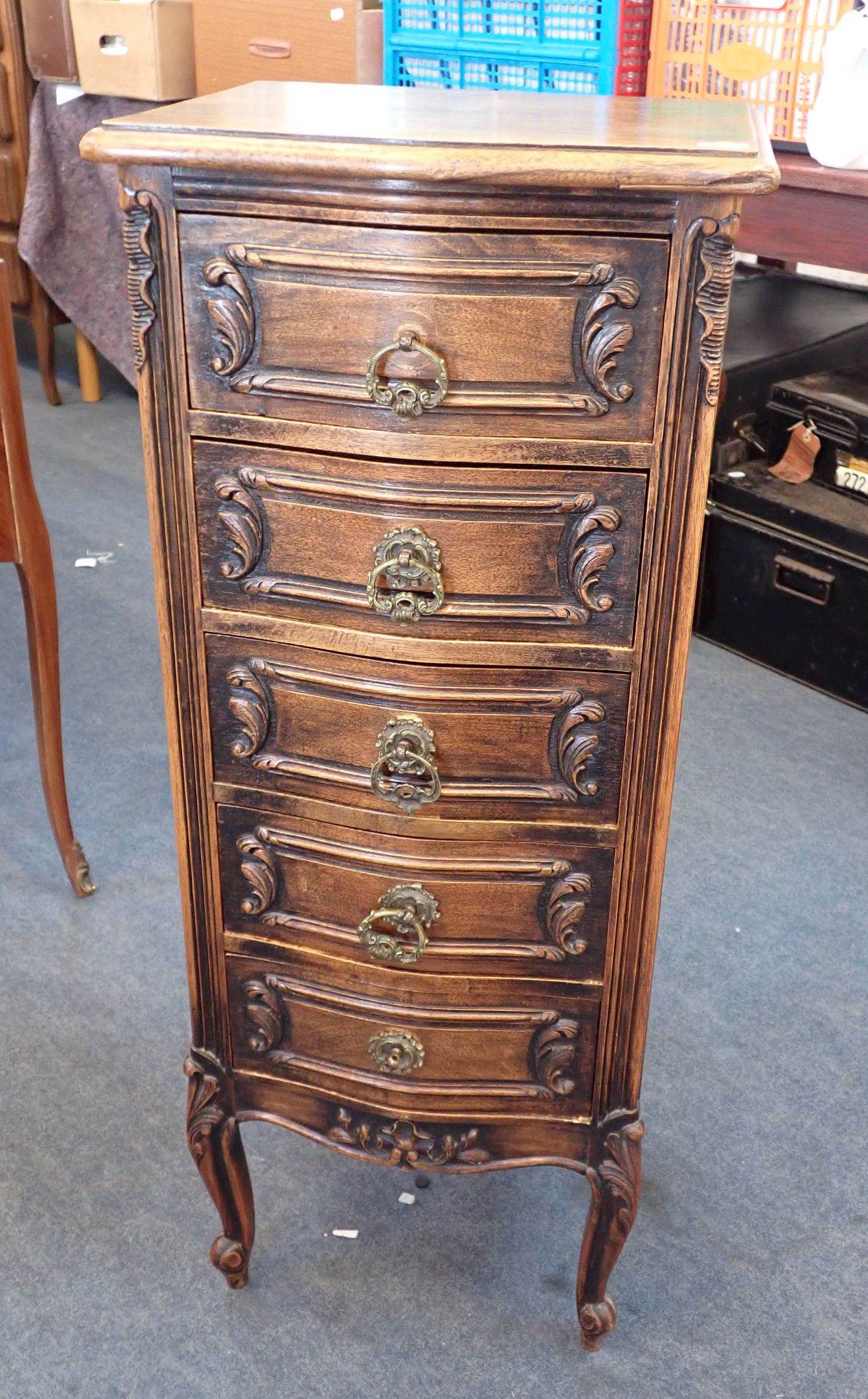 A FRENCH PROVINCIAL STYLE CARVED OAK CHEST OF DRAWERS
