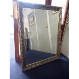 A REPRODUCTION WALL MIRROR WITH SILVERED FRAME