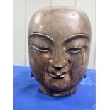 A LARGE ORIENTAL CARVED SOLID GRANITE HEAD OF BUDDHA