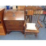 A 20TH CENTURY BUREAU AND A STAINED ROCKING CHAIR