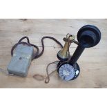 A VINTAGE BRASS AND JAPANNED 'CANDLESTICK' TELEPHONE
