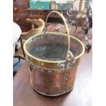 A COPPER AND BRASS BUCKET