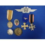 A COLLECTION OF NAZI STYLE MEDALS AND BADGES