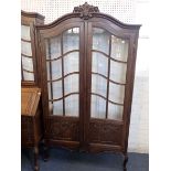 A FRENCH PROVINCIAL STYLE CARVED OAK DISPLAY CABINET