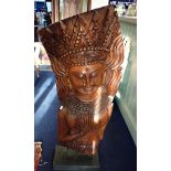 A SUBSTANTIAL ASIAN TEAK CARVING OF A CROWNED FEMALE