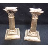 A PAIR OF LOADED SILVER CANDLESTICKS