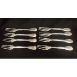 EIGHT WHITE METAL THREE-PRONGED FORKS