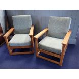 A PAIR OF LIGHT OAK COTSWOLD STYLE ARMCHAIRS