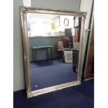 A LARGE SILVER-COLOURED FRAMED MODERN MIRROR