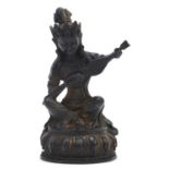 Chino Tibetan gilt bronze figure of a deity playing an instrument, 21.5cm high