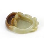 Chinese naturalistic celadon and russet jade brush washer carved with a water dragon, 8.5cm wide