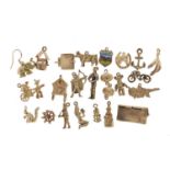 Collection of silver charms including Rupert Bear, hinged first aid box, vintage motorcycle,