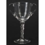 Antique twin handled glass cup with twist stem, 14cm high