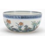 Chinese doucai porcelain bowl hand painted with ducklings in water amongst lily pads and flowers,