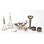 Silver items including two cut glass bottles with silver mounts, bud vase and napkin rings,