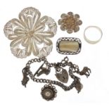 Silver jewellery including a charm bracelet, two filigree brooches, filigree ring and mother of