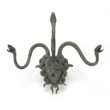 Early 20th century patinated bronze wall mask of Medusa with three serpent hangers, 31cm high