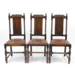 Three carved oak dining chairs with barley twist supports and drop in seats, each 106cm high