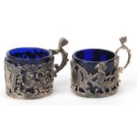 Two Edwardian silver glass holders with blue glass inserts including one by William Comyns & Sons,