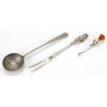 Silver items comprising an unmarked Persian spoon, pickle fork and button hook, the largest 14.5cm