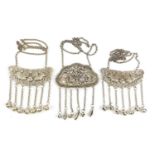 Two Chinese silver coloured metal embossed pendants with bells, each approximately 11cm wide
