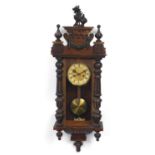 Carved oak wall clock with Roman numerals, 94cm high