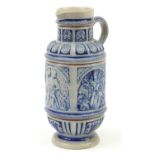 German salt glazed jug decorated with crests and figures, 29cm high