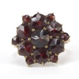 Antique gold coloured metal garnet cluster ring stamped 333, size I, 2.8g