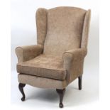Mahogany framed wingback arm chair with contemporary upholstery, 102cm high