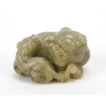 Chinese celadon and russet jade carving of two mythical lions, 6cm wide