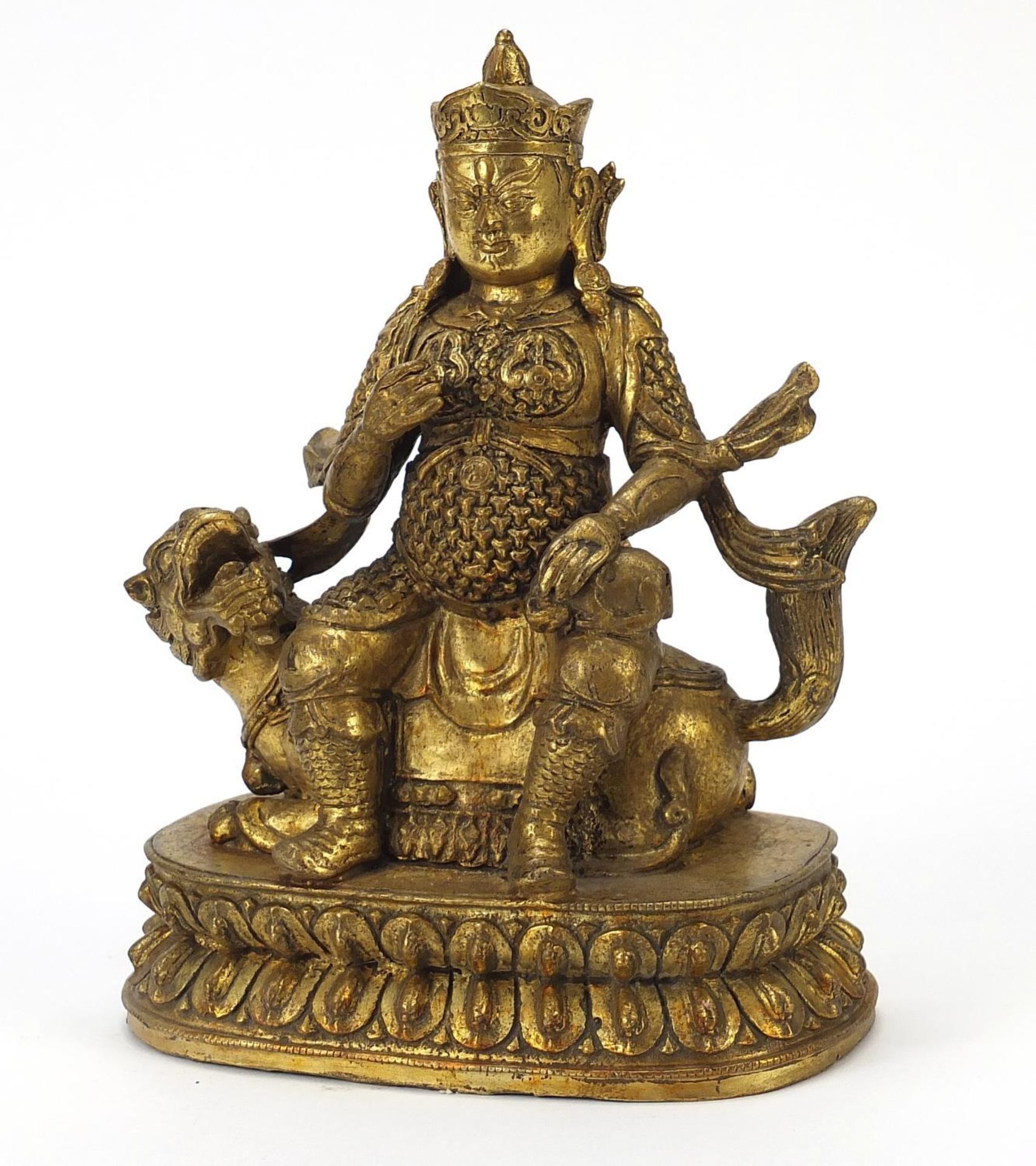 Chino Tibetan patinated gilt bronze figure of an Emperor on mythical animal, 23.5cm high
